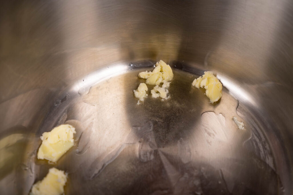 Make popcorn: Melt butter in pot