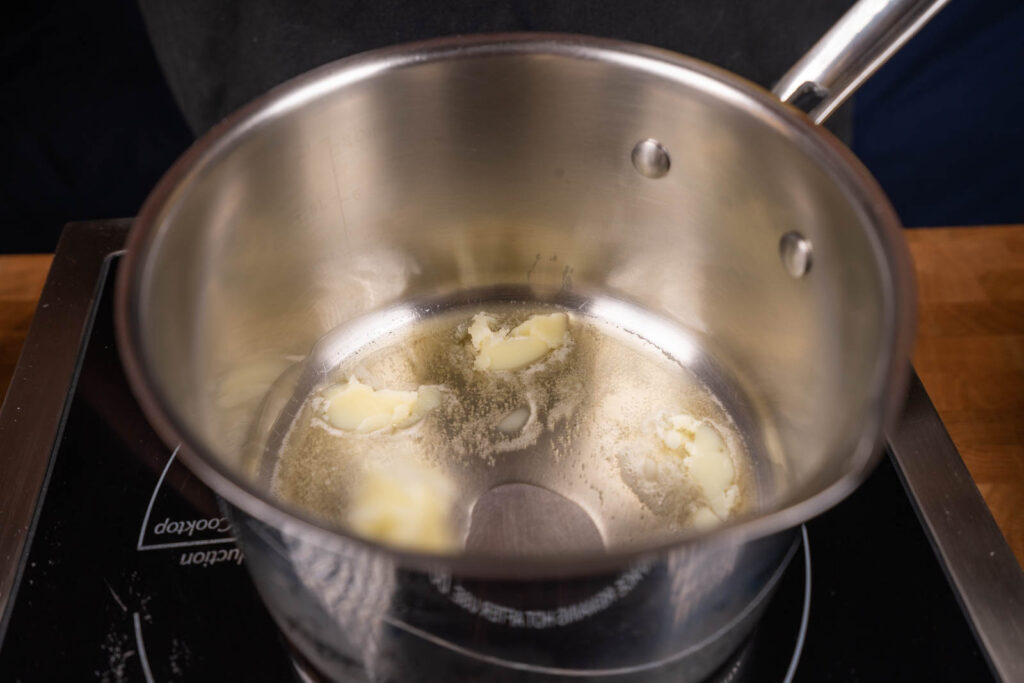 Make popcorn: Melt more butter